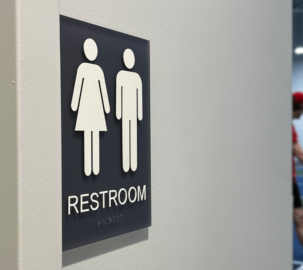 ADA gray acrylic restroom sign with braille